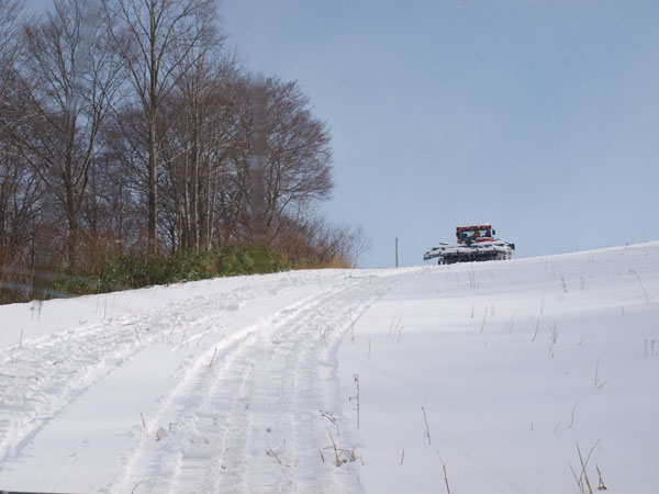 Groomers race up the hill charge up the hill